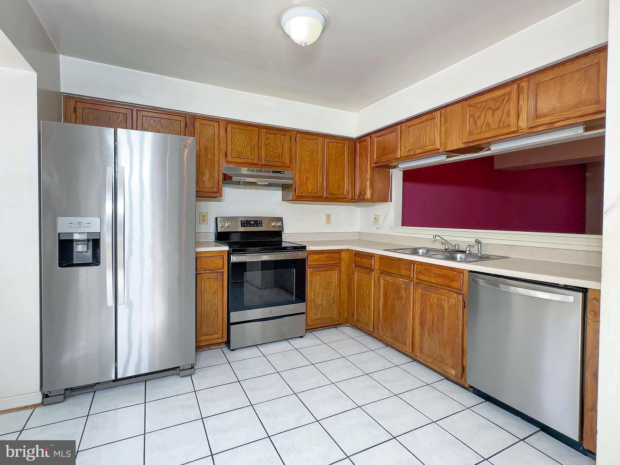 8578 Ritchboro Road District Heights, MD 20747 - Photo 5 of 31 a kitchen with stainless steel appliances granite countertop a refrigerator sink and cabinets