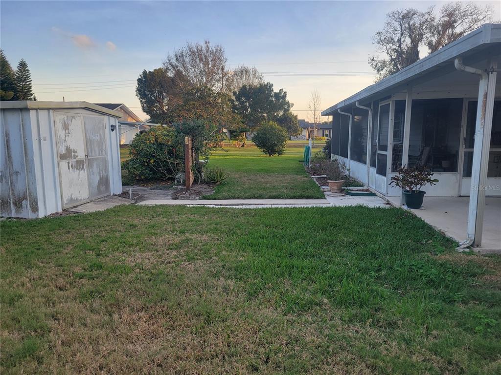 7 Wisconsin Avenue St. Cloud, FL 34769 - Photo 18 of 18 a view of a backyard with potted plants and large tree
