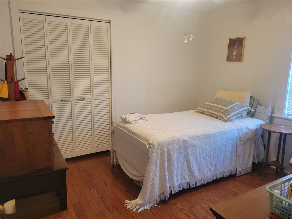 7 Wisconsin Avenue St. Cloud, FL 34769 - Photo 6 of 18 a bedroom with a bed and a mirror