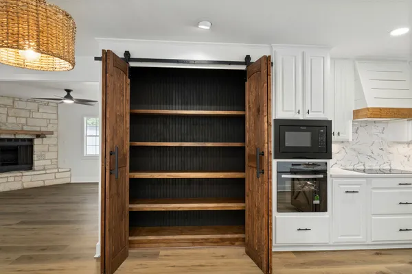 a view of kitchen and utility room with wooden floor