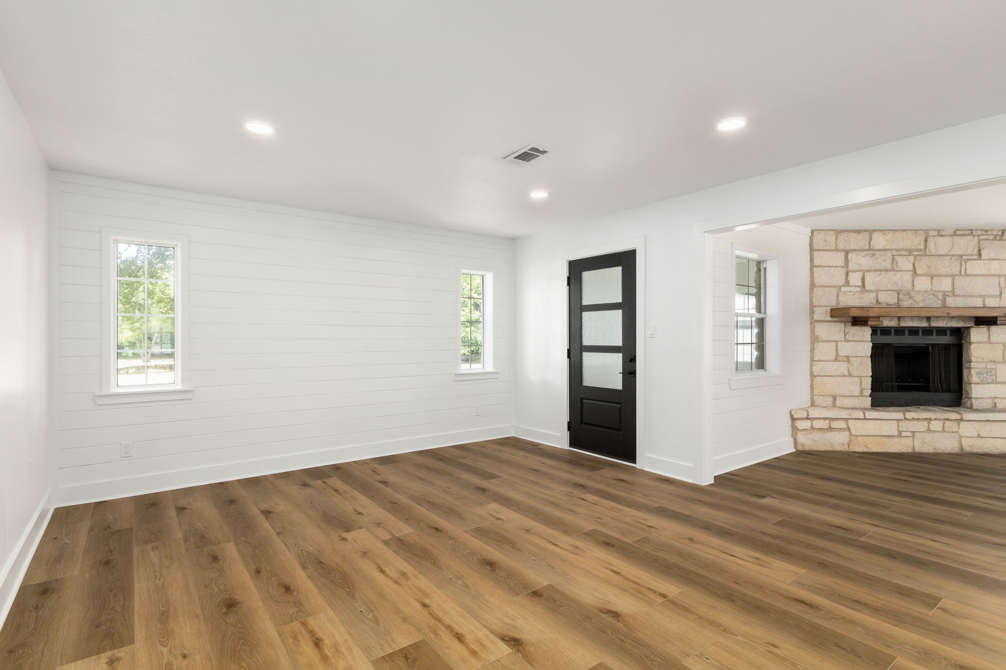 1195 Track Road New Ulm, TX 78950 - Photo 16 of 49 a view of empty room with wooden floor and fireplace