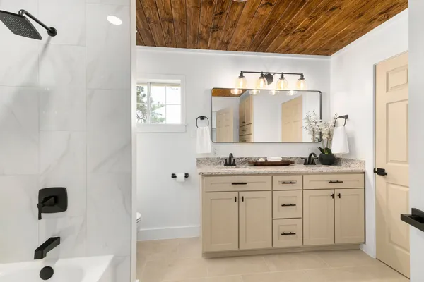 a bathroom with a bathtub a toilet and a shower