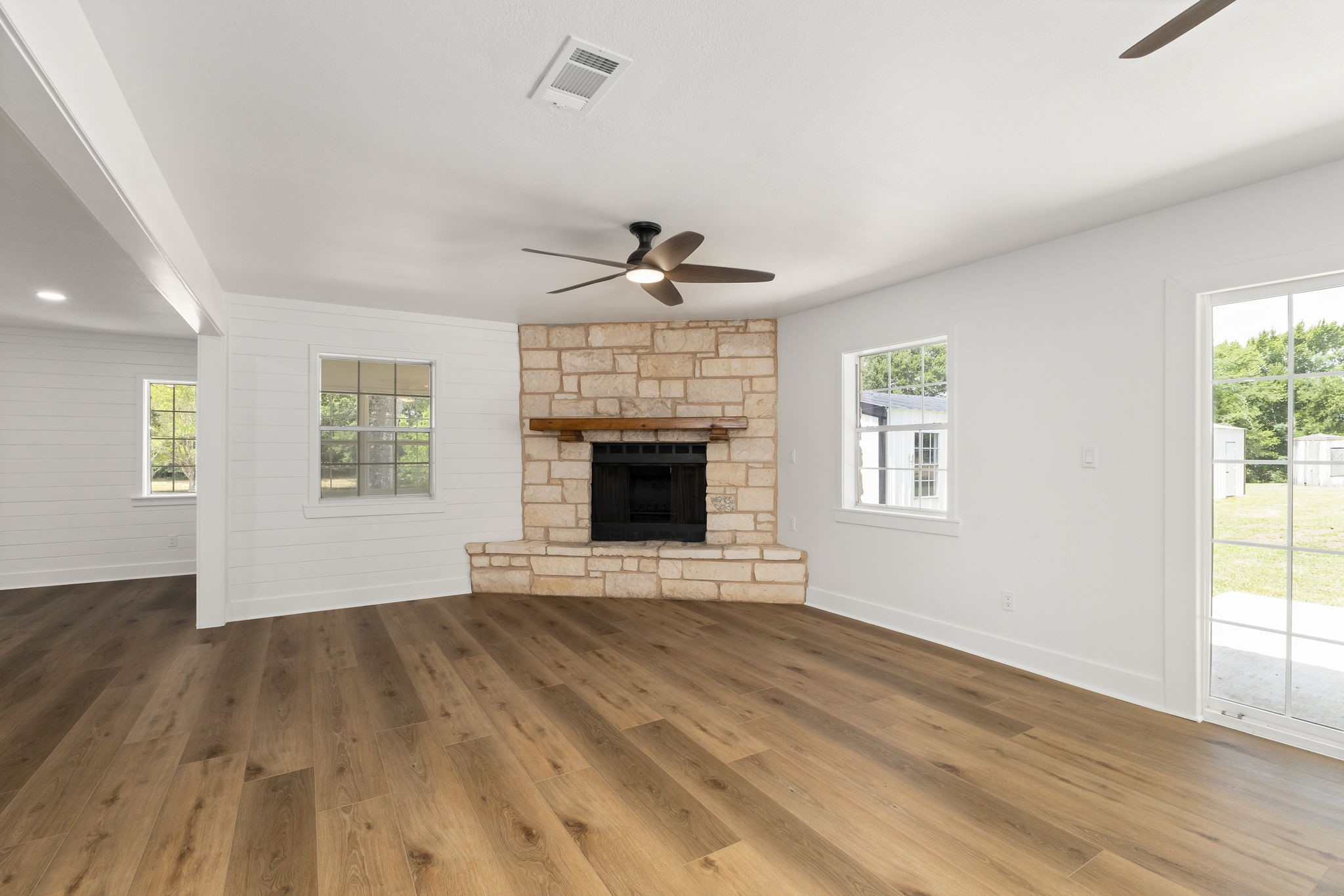 1195 Track Road New Ulm, TX 78950 - Photo 24 of 49 an empty room with wooden floor a ceiling fan and windows