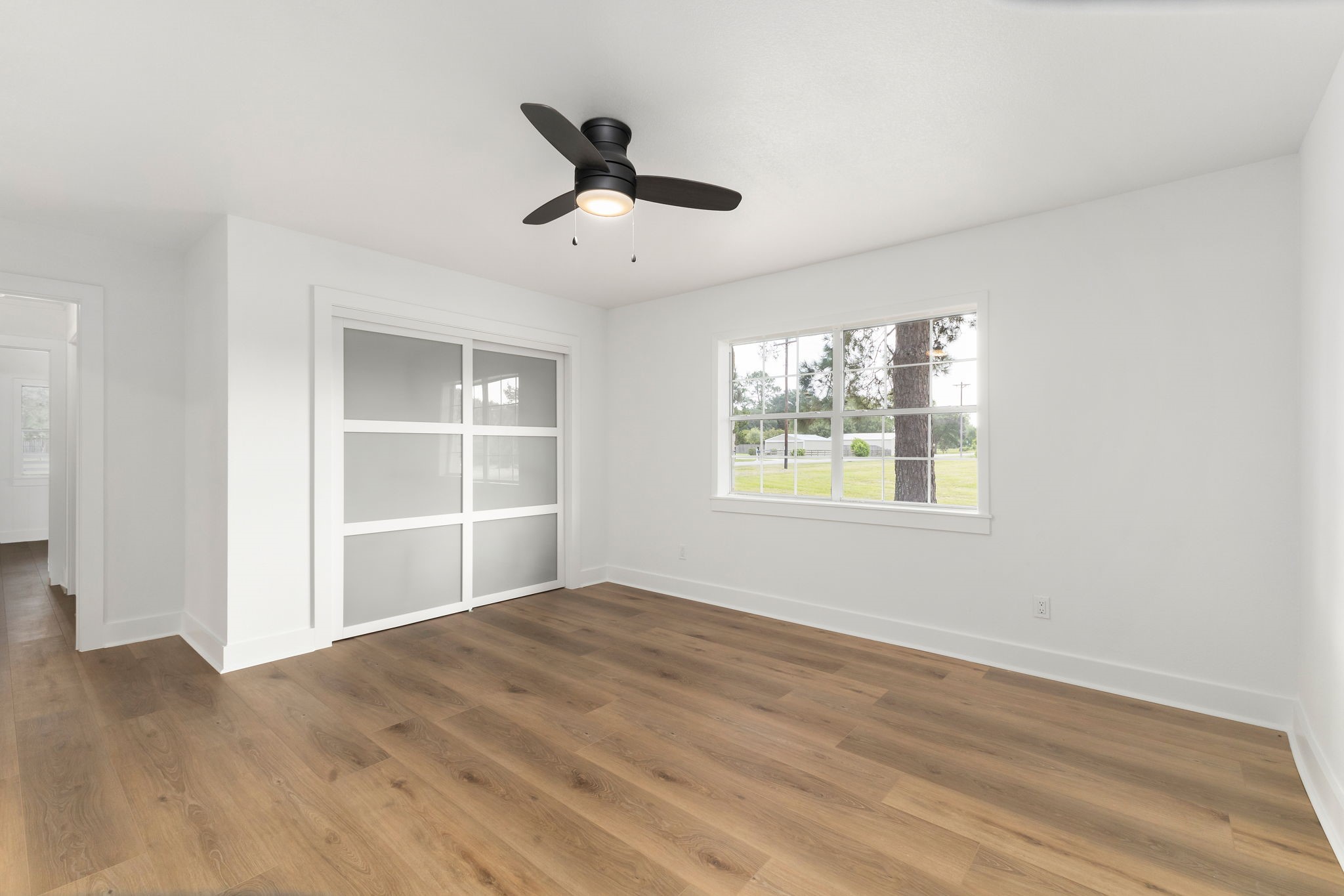 1195 Track Road New Ulm, TX 78950 - Photo 32 of 49 a view of an empty room with a window and wooden floor