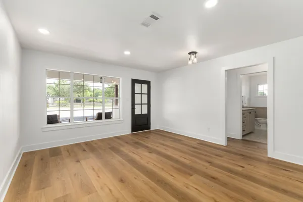 wooden floor in an empty room with a large window