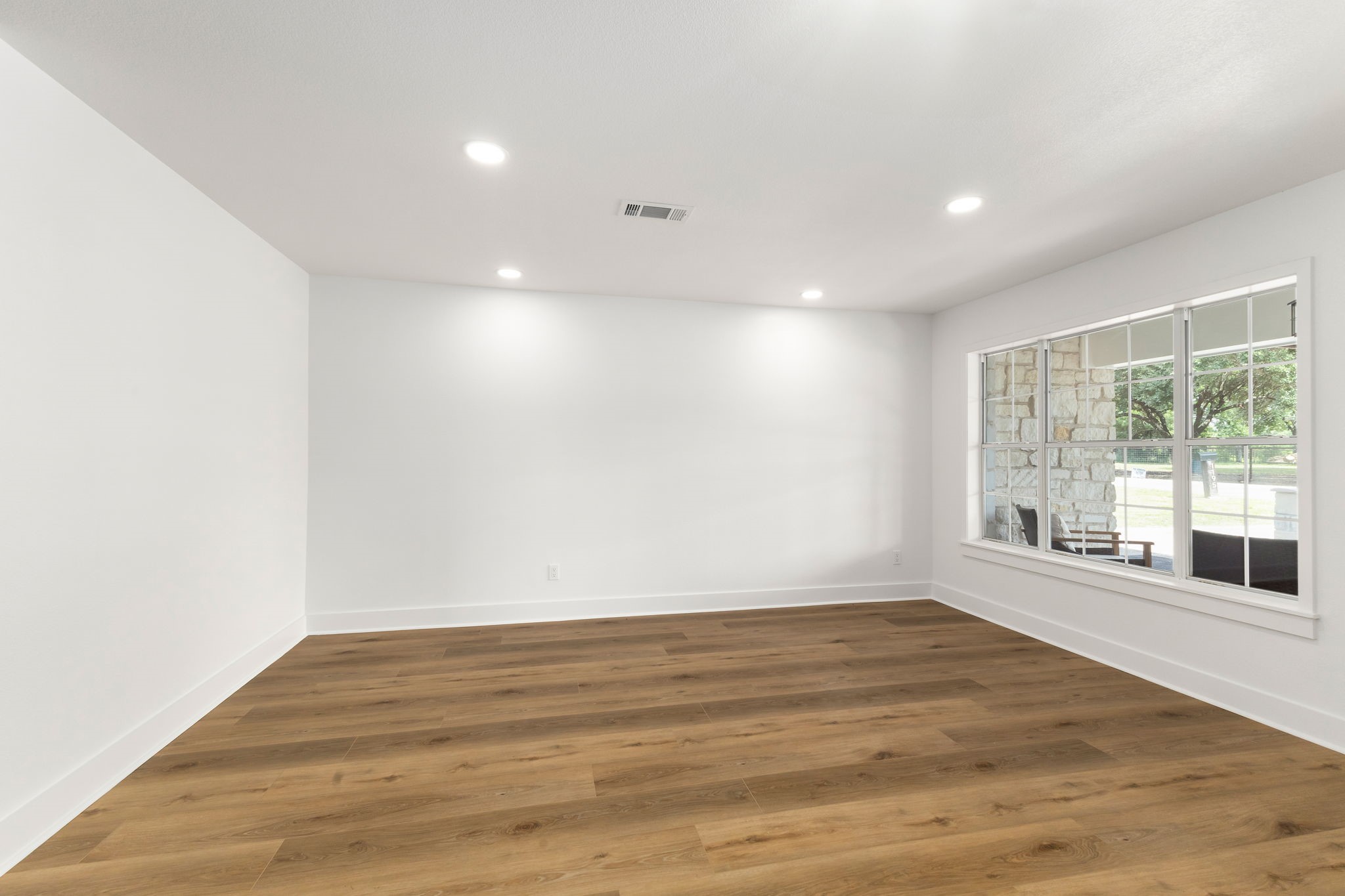 1195 Track Road New Ulm, TX 78950 - Photo 34 of 49 a view of an empty room with wooden floor and a window