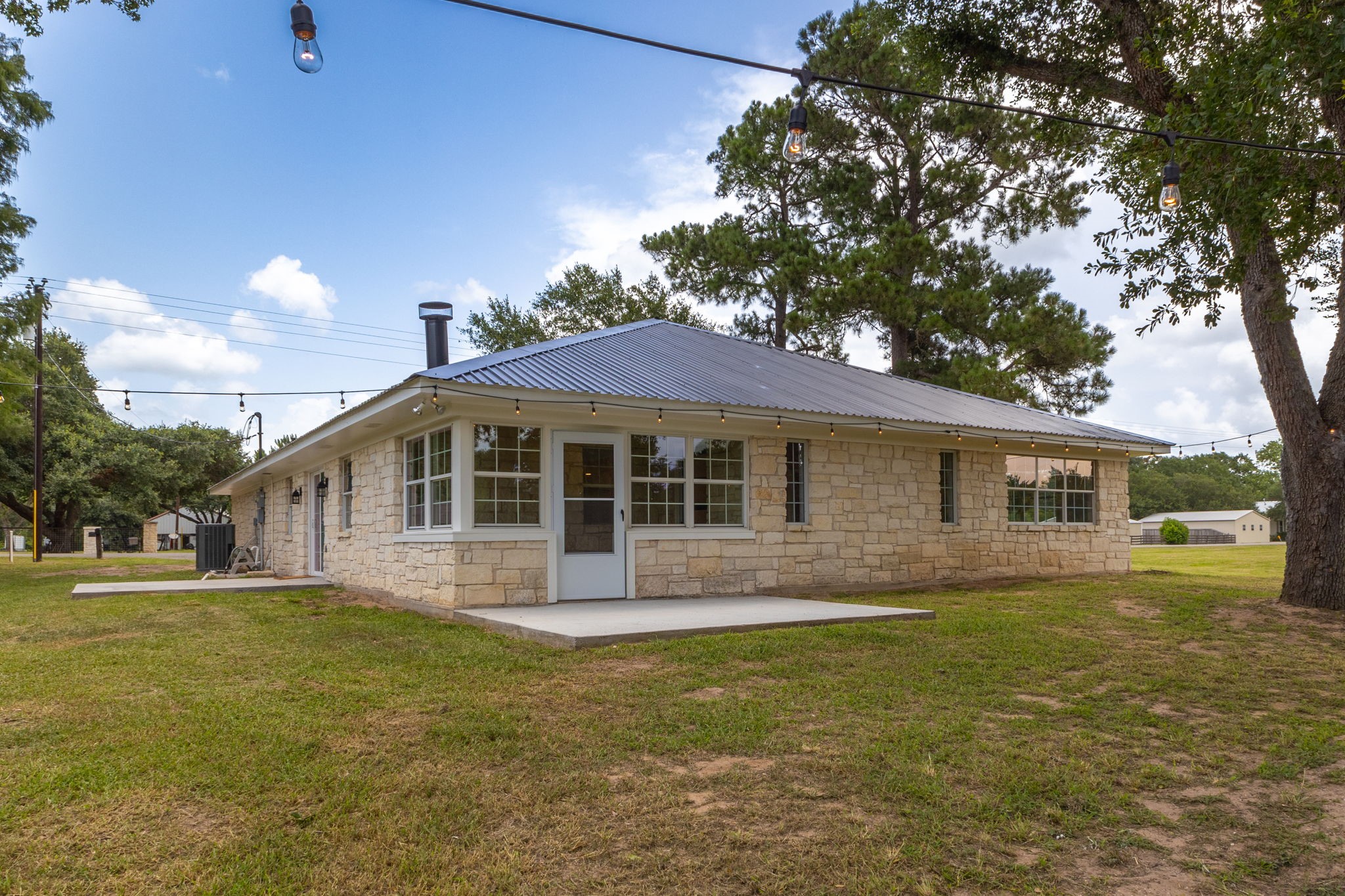 1195 Track Road New Ulm, TX 78950 - Photo 36 of 49 a front view of a house with a garden