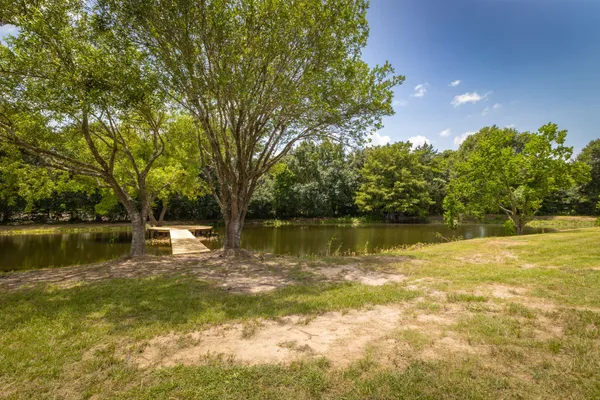 a view of a lake with houses in the background