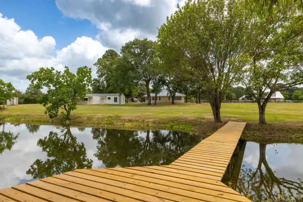 a house view with swimming pool in front of it