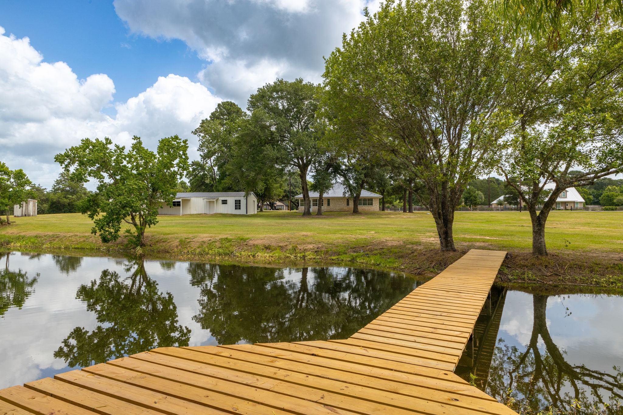1195 Track Road New Ulm, TX 78950 - Photo 40 of 49 Tranquil retreat featuring a charming wooden pier, perfect for relaxation and enjoying serene views.
