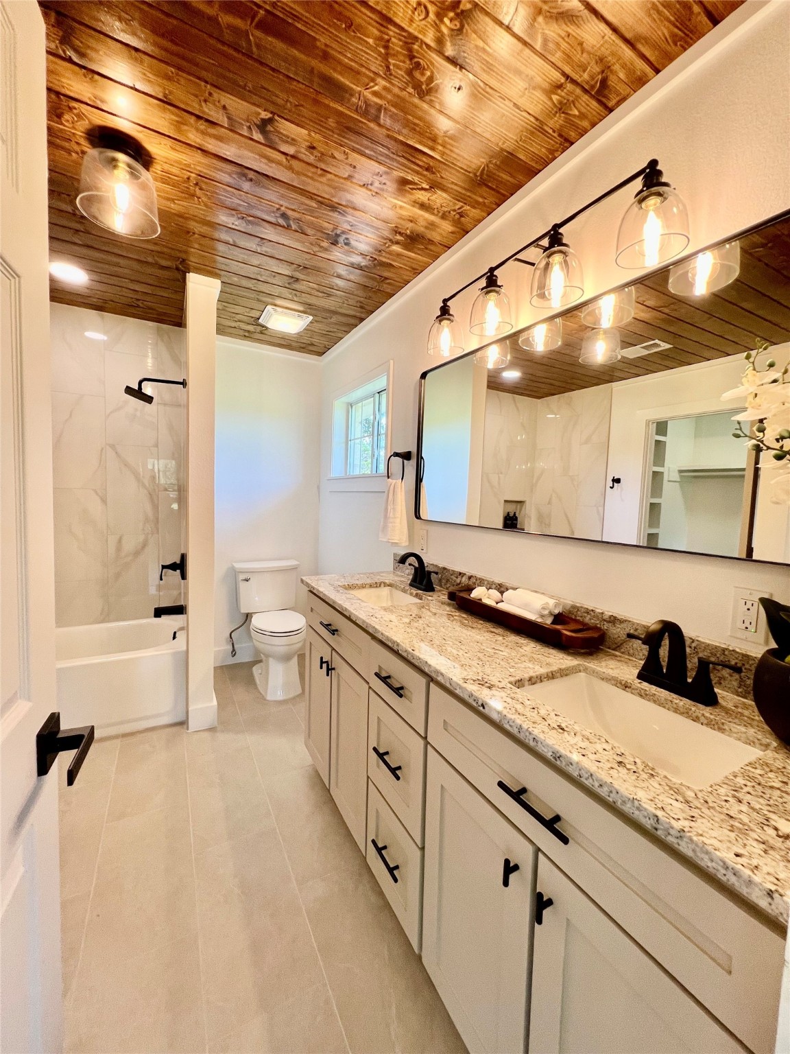 1195 Track Road New Ulm, TX 78950 - Photo 4 of 49 a large bathroom with a granite countertop sink mirror and a shower