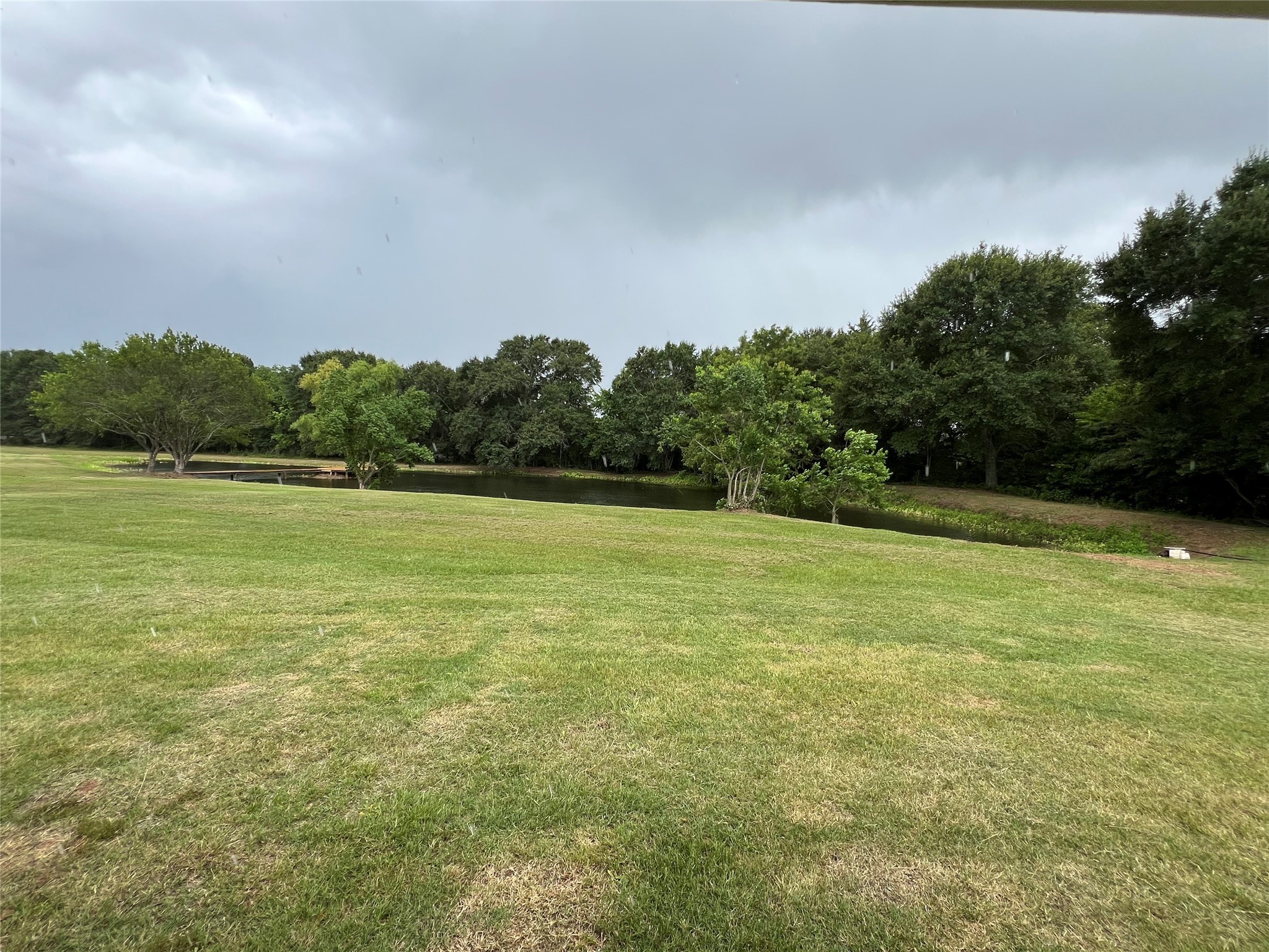 1195 Track Road New Ulm, TX 78950 - Photo 47 of 49 Backyard view of pond