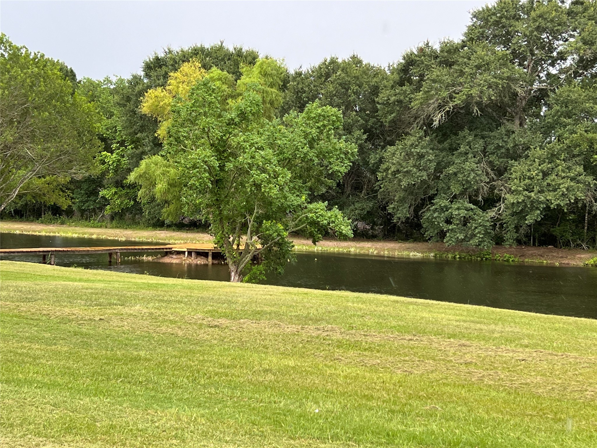 1195 Track Road New Ulm, TX 78950 - Photo 48 of 49 a view of a lake with a yard