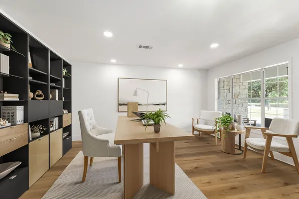 a living room with fireplace furniture and a potted plant