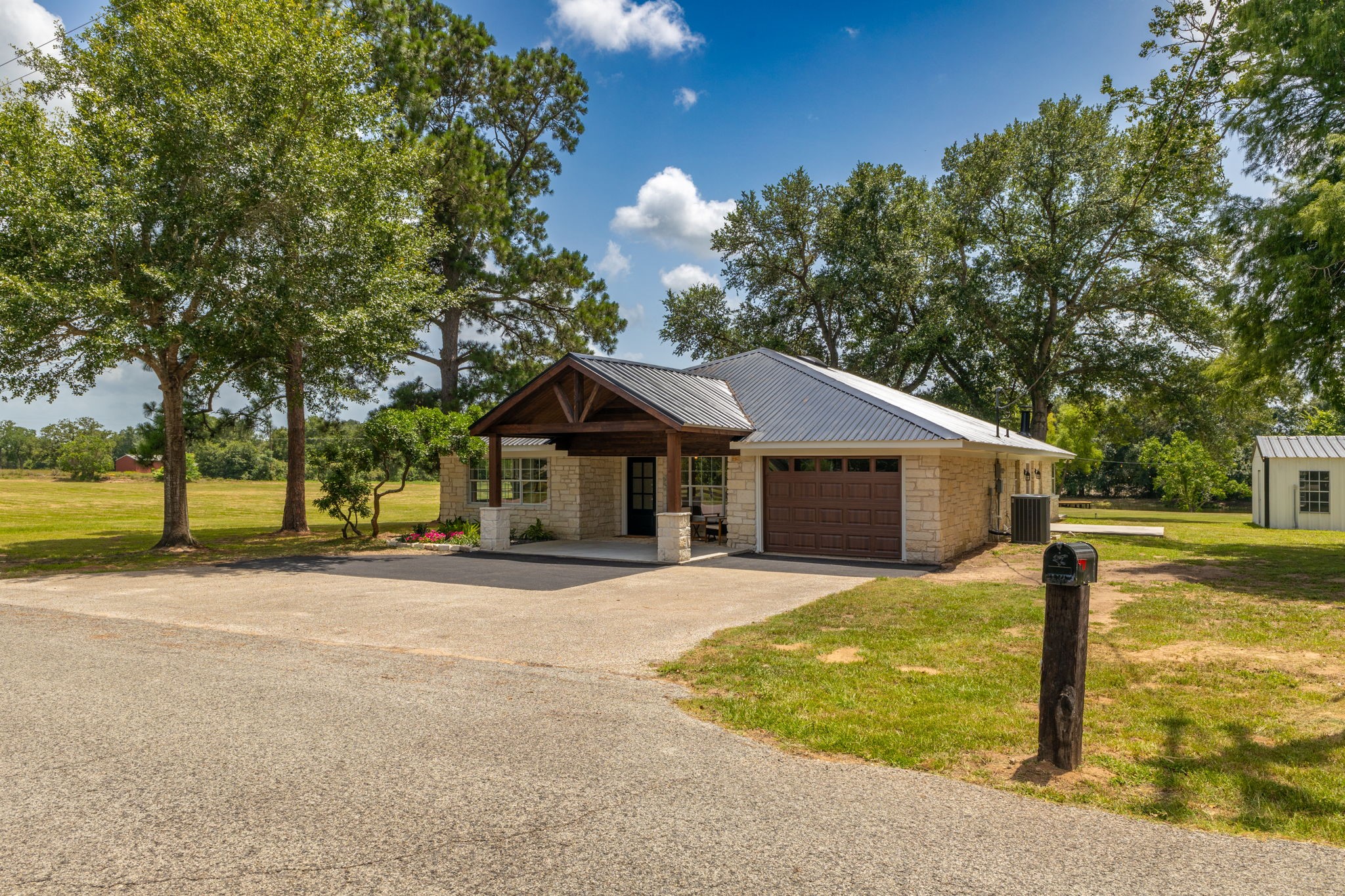 1195 Track Road New Ulm, TX 78950 - Photo 9 of 49 a front view of a house with a yard and trees