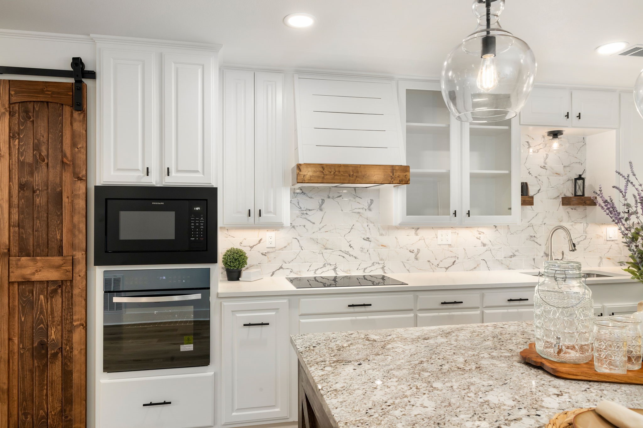 1195 Track Road New Ulm, TX 78950 - Photo 10 of 49 a kitchen with granite countertop white cabinets and stainless steel appliances