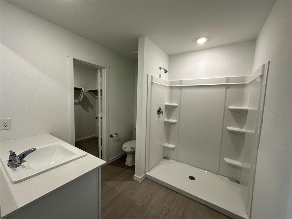 1613 Elliott Road Howe, TX 75459 - Photo 11 of 13 a bathroom with a shower sink mirror and toilet