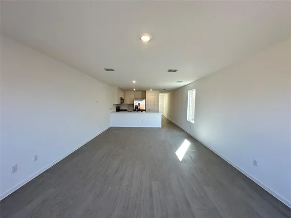a view of a room with wooden floor