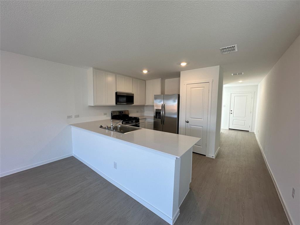 1613 Elliott Road Howe, TX 75459 - Photo 4 of 13 a kitchen with stainless steel appliances a refrigerator sink and microwave