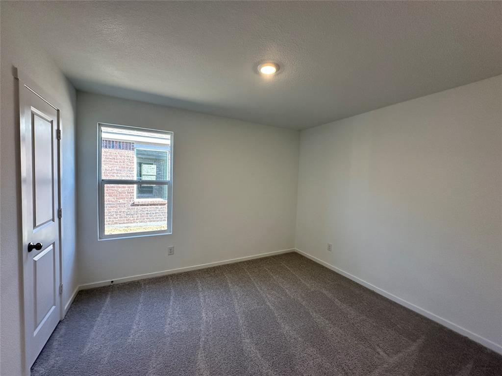 1613 Elliott Road Howe, TX 75459 - Photo 9 of 13 an empty room with a window
