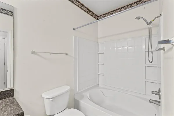 a bathroom with a toilet and a shower