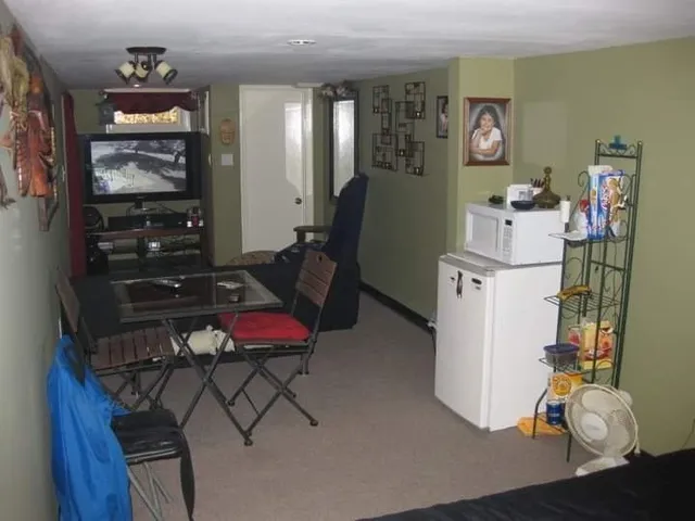 a bedroom with furniture and a dresser