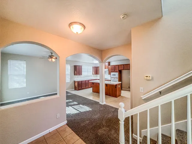 a view of a livingroom with furniture and staircase