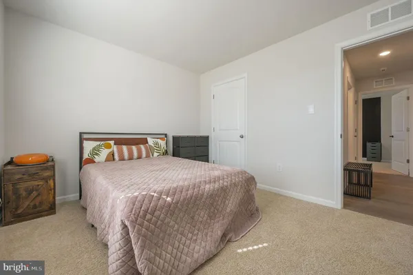 a bedroom with a bed and dresser