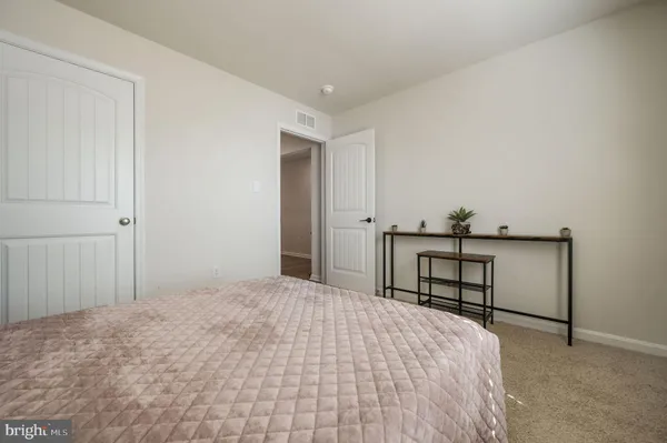 a bedroom with a bed and a dresser