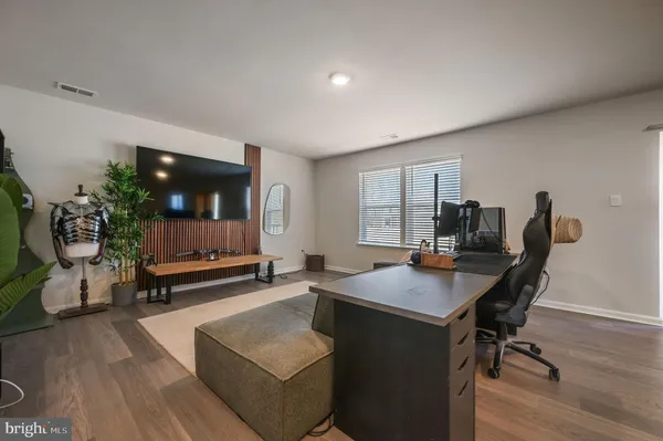 a view of a workspace with furniture and window