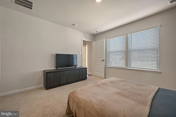 a bedroom with a bed and a television