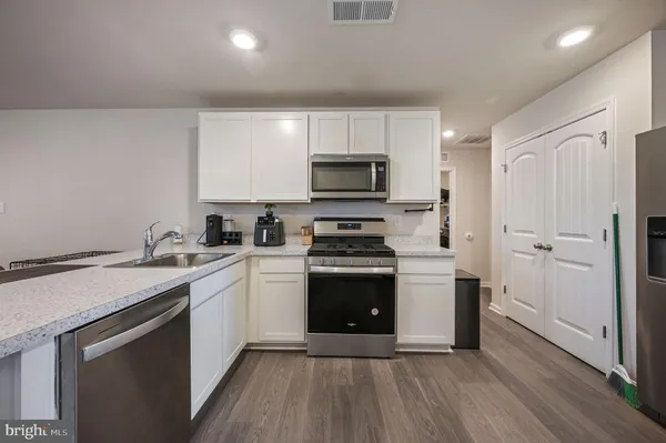 a kitchen with a sink stove and refrigerator