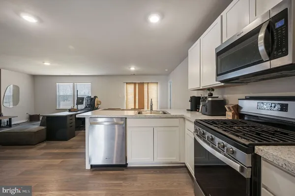 a kitchen with a stove a sink and a microwave