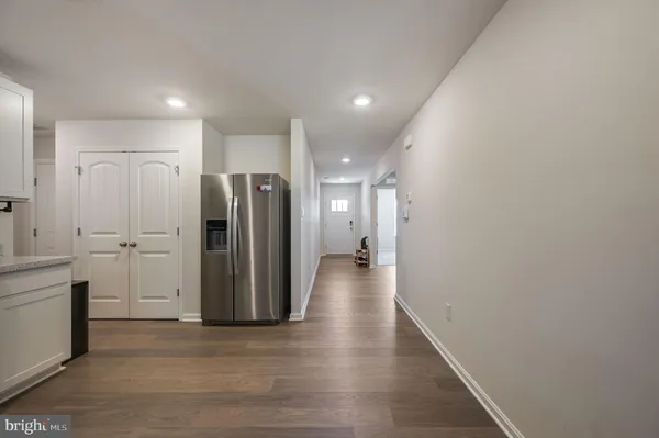 a view of a hallway with wooden floor