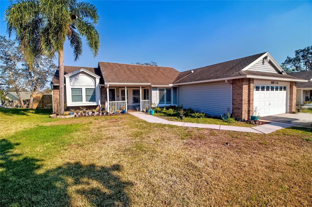 1090 Aladdin Road Spring Hill, FL 34609 - Photo 1 of 1 a view of a yard in front of a house with a large tree