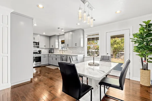 a kitchen with stainless steel appliances a refrigerator sink and microwave