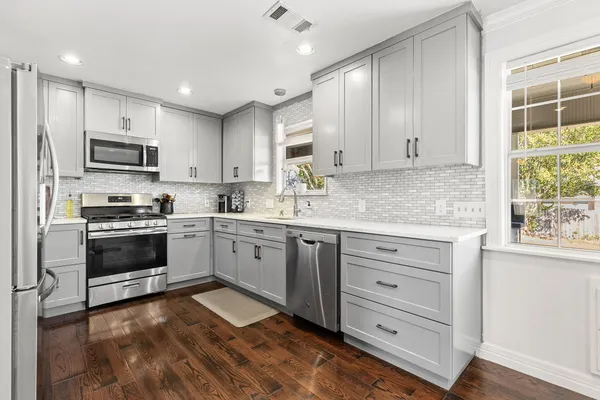 a kitchen with a sink cabinets and window