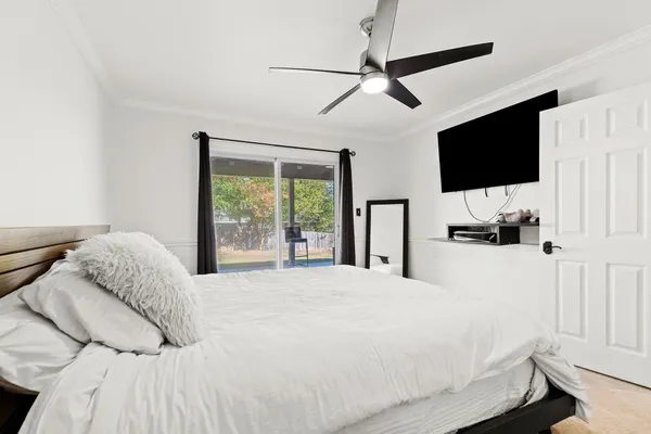 a large bed in a bedroom next to a lamp