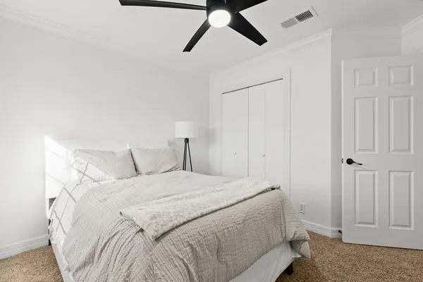 a living room with furniture and a ceiling fan