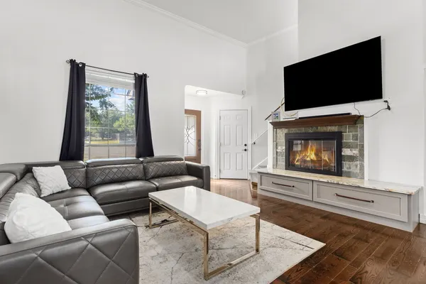 a living room with furniture and wooden floor