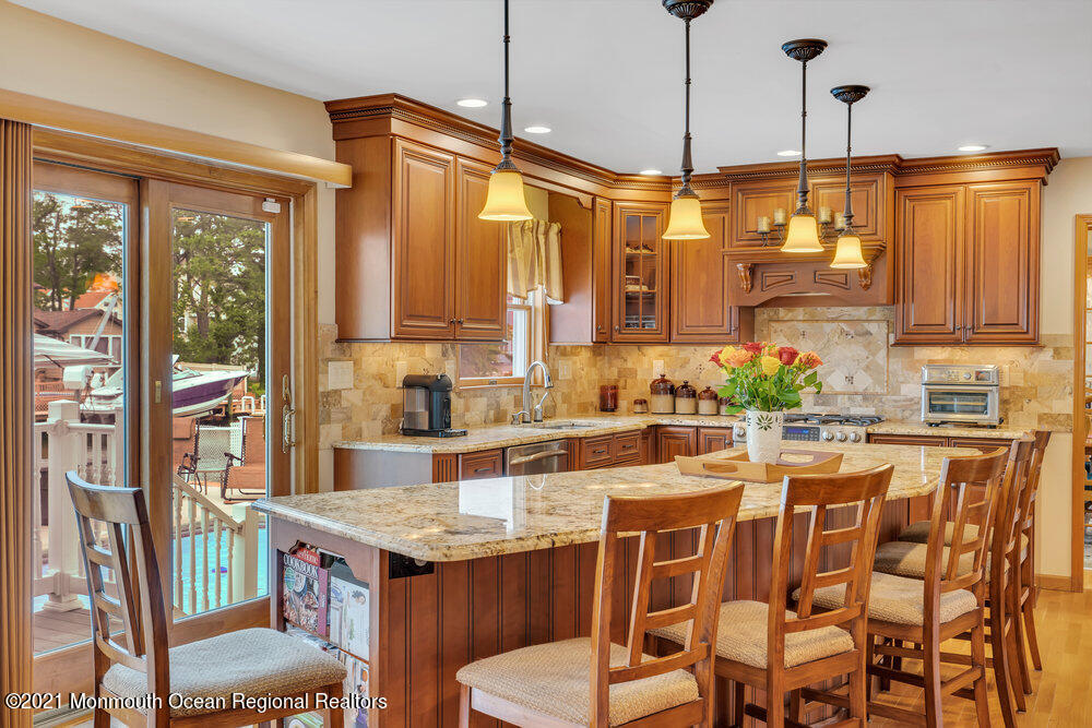 37 Channel Road Toms River, NJ 08753 - Photo 14 of 57 a kitchen with a stove a refrigerator and wooden floor