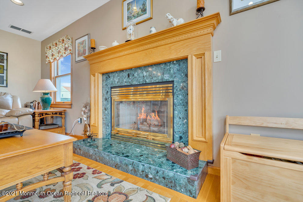 37 Channel Road Toms River, NJ 08753 - Photo 23 of 57 a living room with furniture and a fireplace