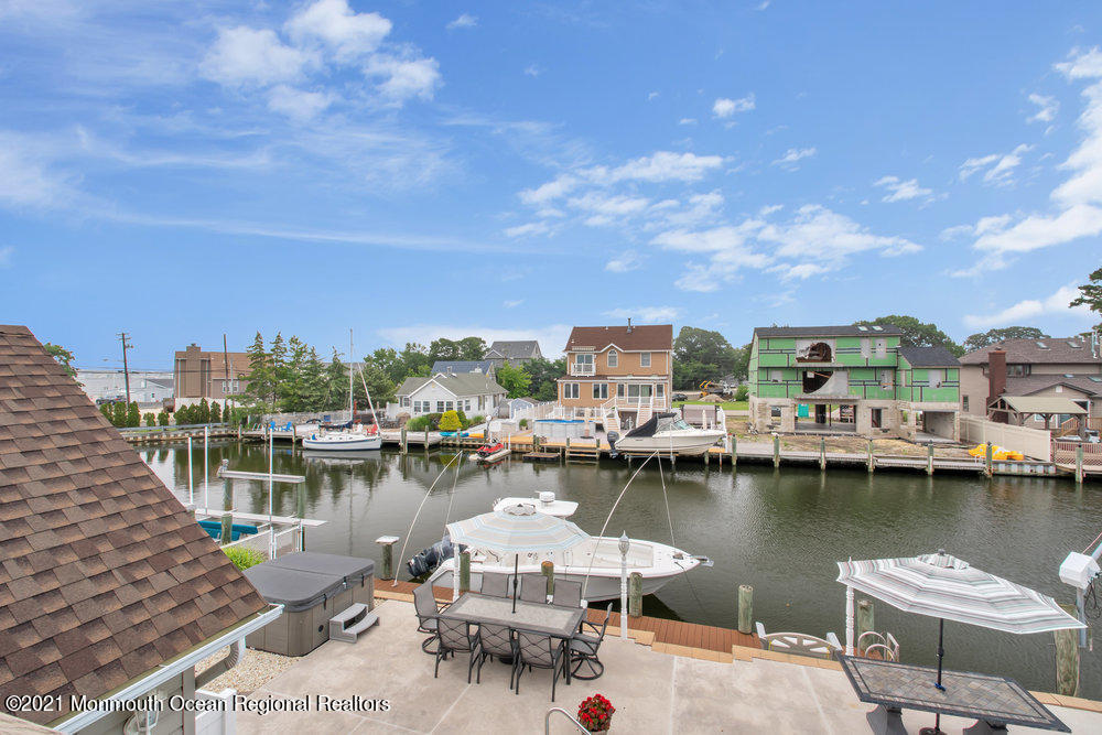 37 Channel Road Toms River, NJ 08753 - Photo 40 of 57 a view of a lake with boats and trees in the background