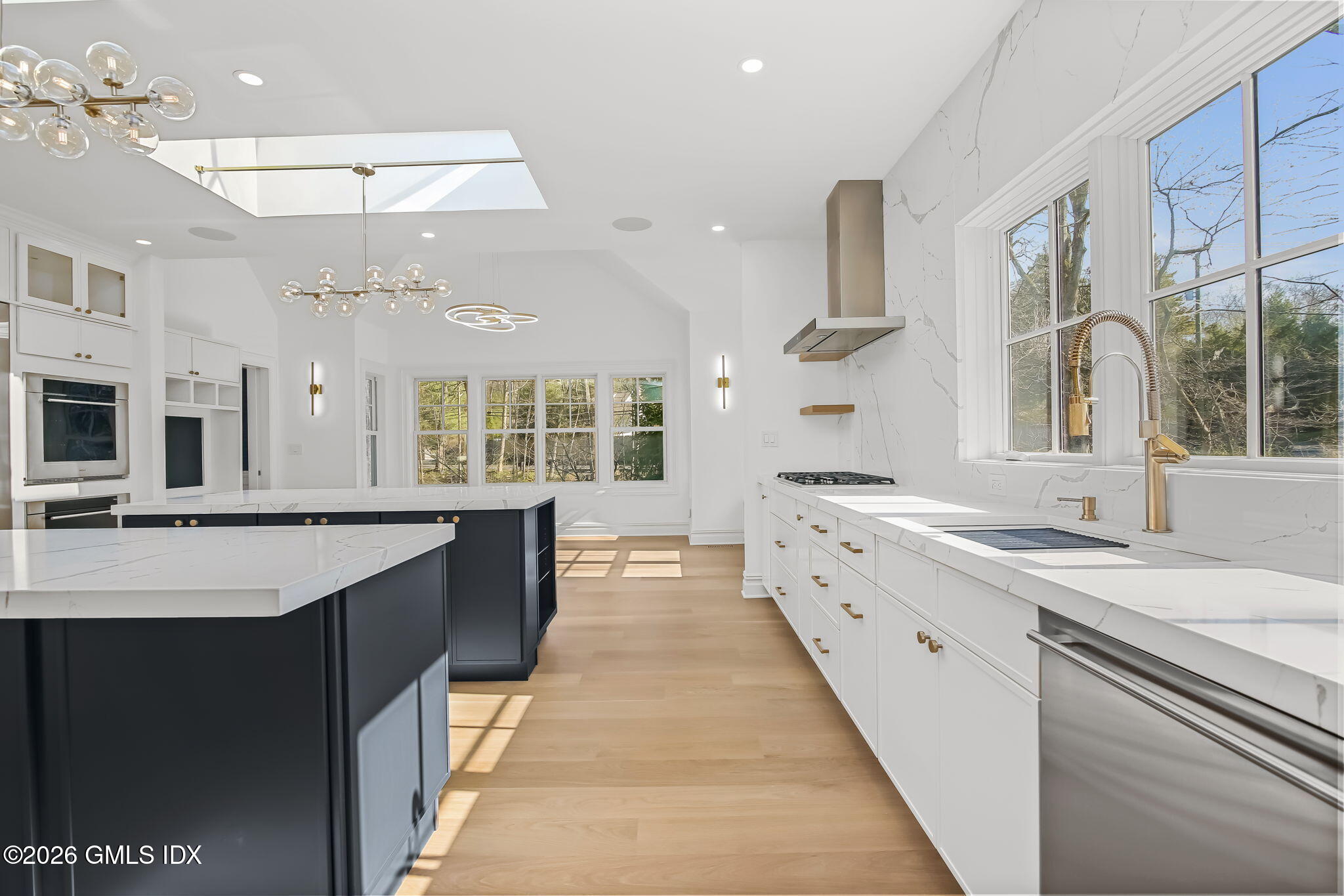 7 Bailiwick Road Greenwich, CT 06831 - Photo 13 of 42 a large kitchen with stainless steel appliances kitchen island granite countertop a sink and cabinets