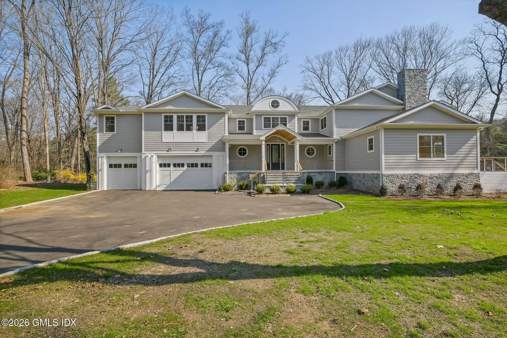 7 Bailiwick Road Greenwich, CT 06831 - Photo 2 of 42 a front view of a house with a yard table and chairs