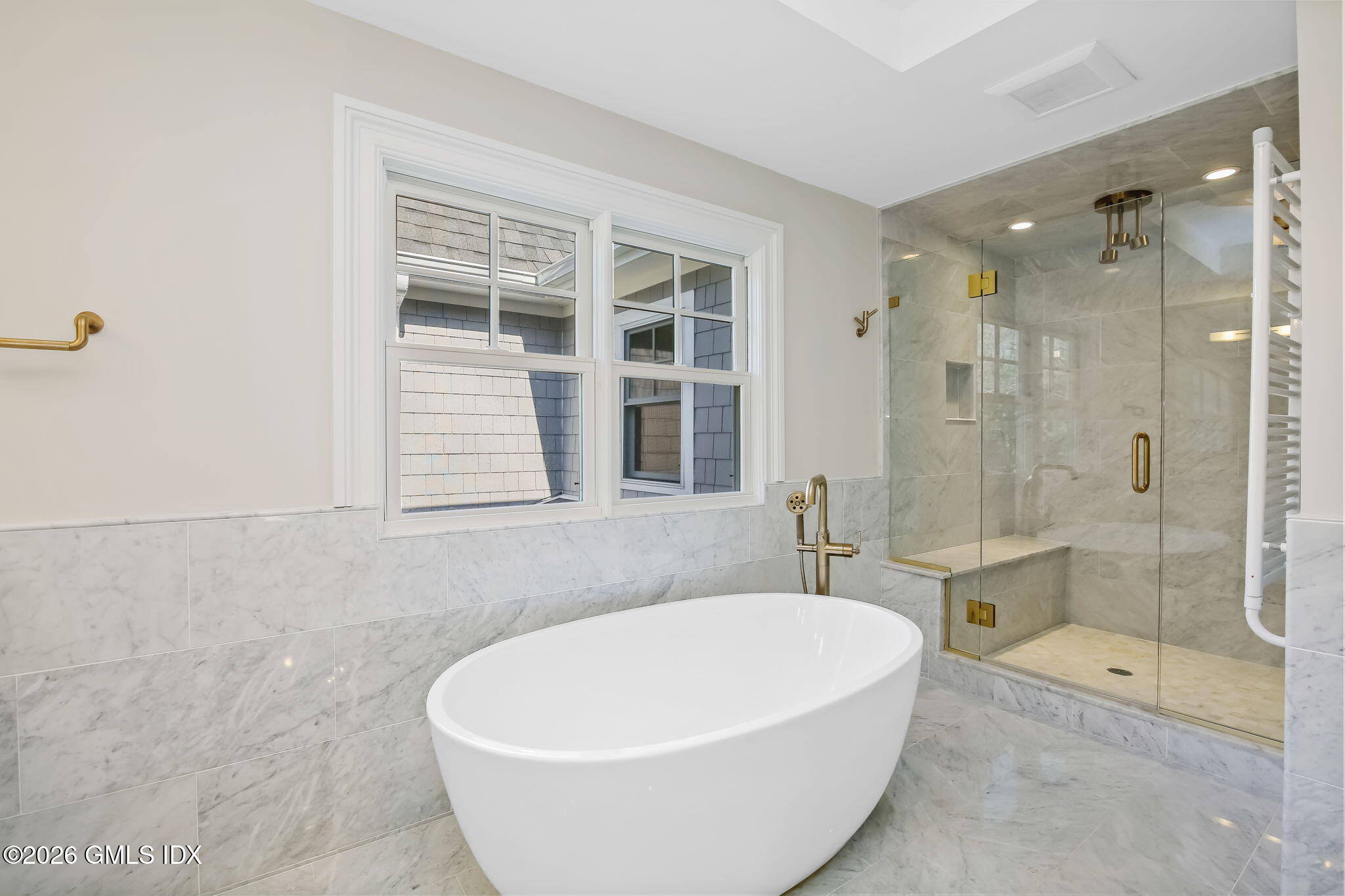 7 Bailiwick Road Greenwich, CT 06831 - Photo 22 of 42 a white bath tub sitting next to a bathroom and shower