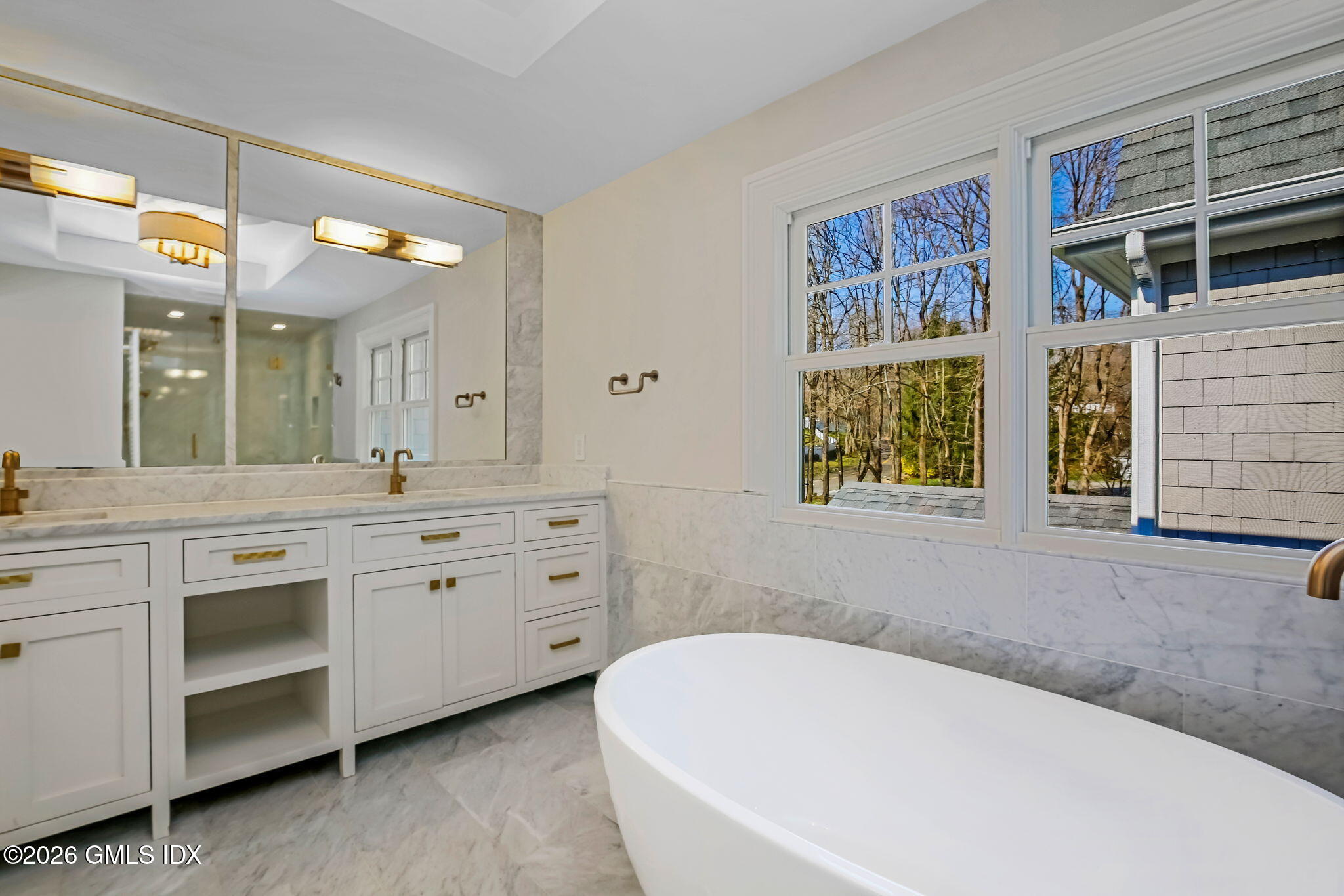 7 Bailiwick Road Greenwich, CT 06831 - Photo 23 of 42 a bathroom with a granite countertop sink mirror and a bathtub