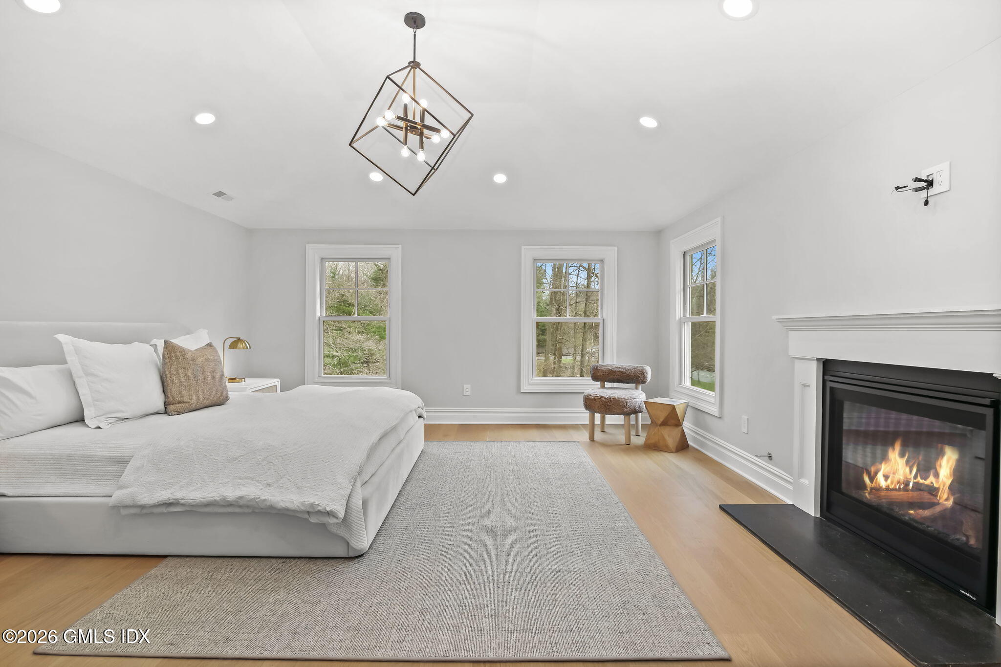 7 Bailiwick Road Greenwich, CT 06831 - Photo 24 of 42 a spacious bedroom with a bed and a fireplace