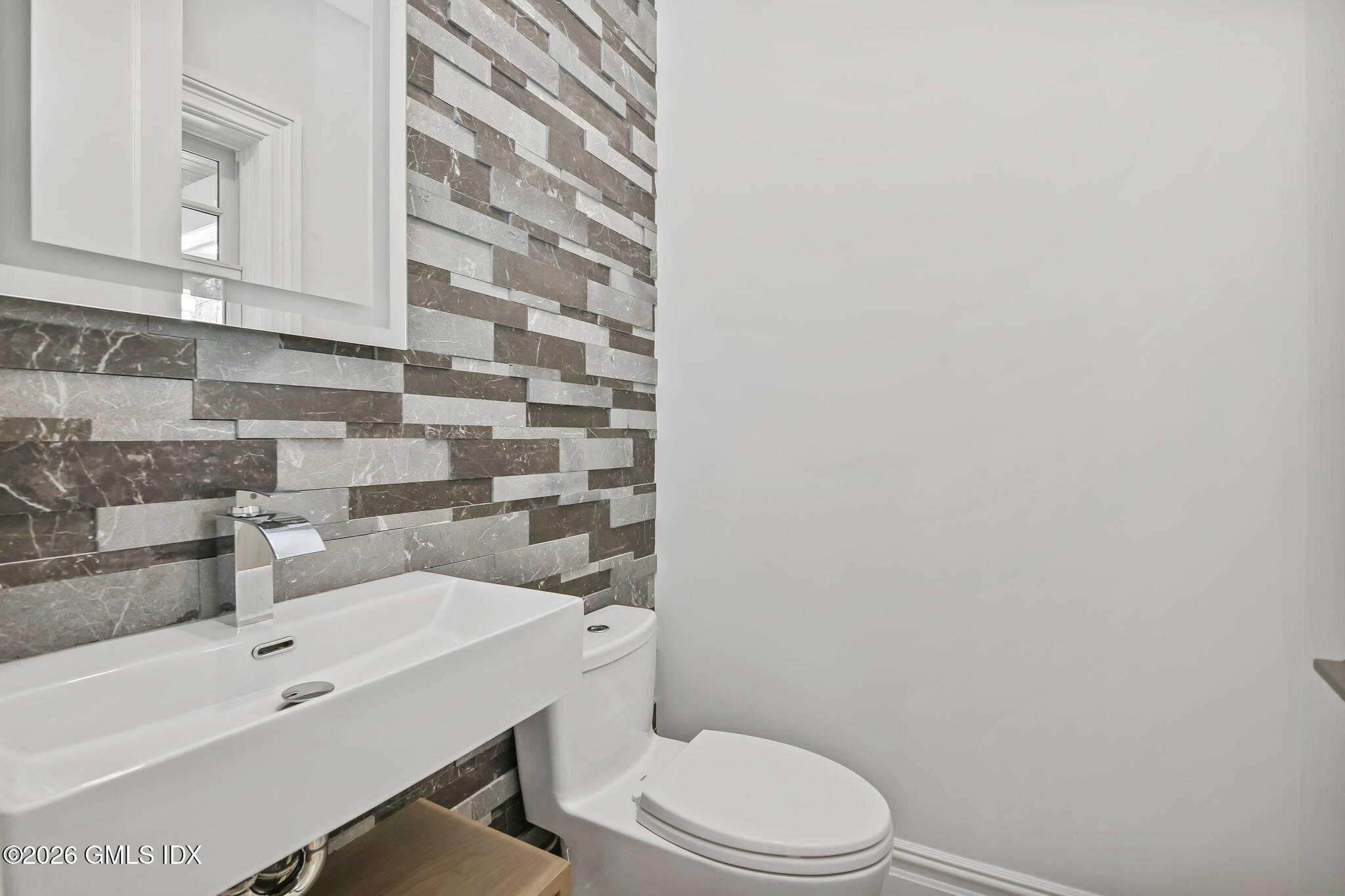 7 Bailiwick Road Greenwich, CT 06831 - Photo 40 of 42 a bathroom with a sink a toilet and shower