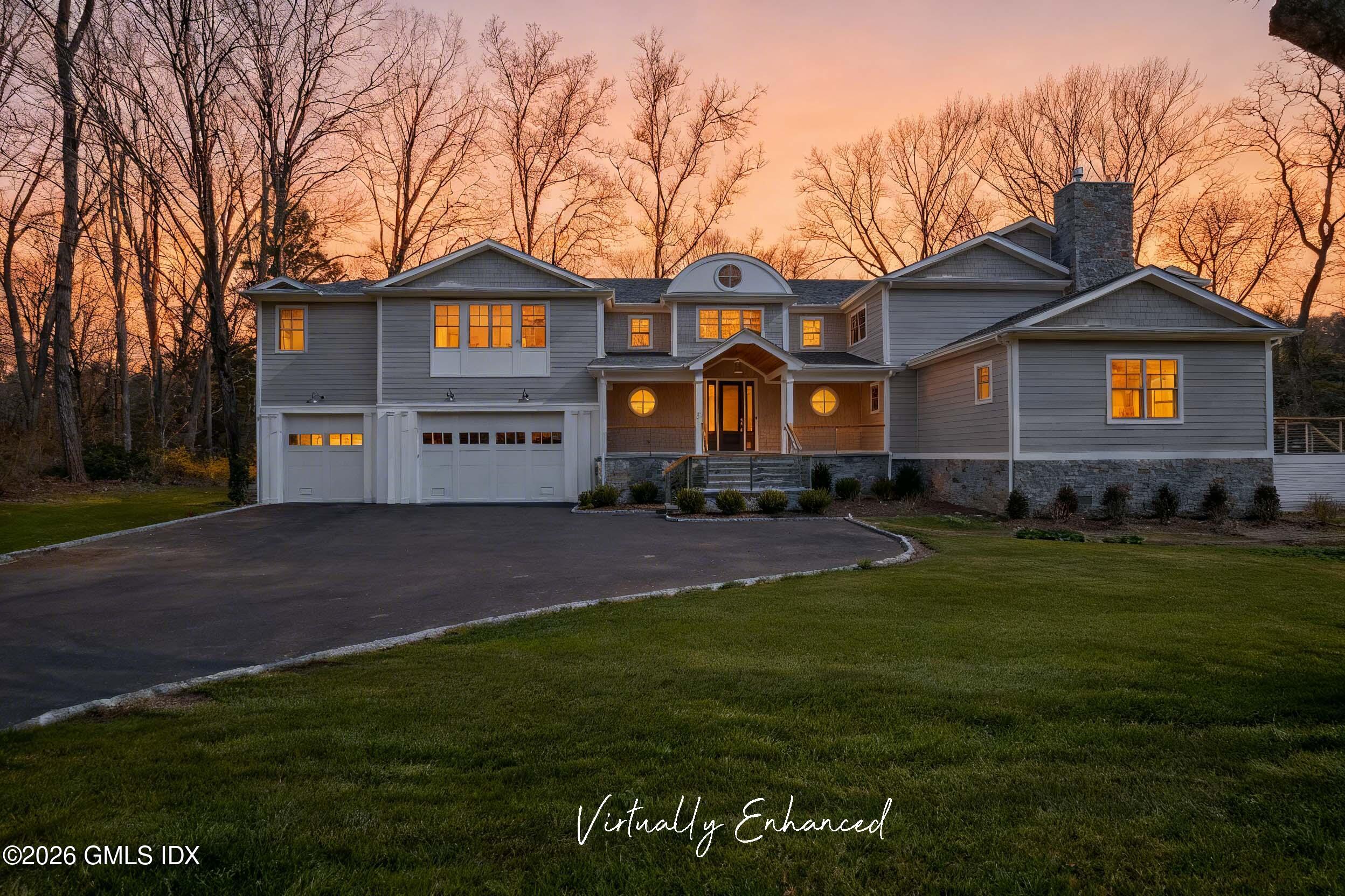 7 Bailiwick Road Greenwich, CT 06831 - Photo 42 of 42 a front view of a house with a yard and garage